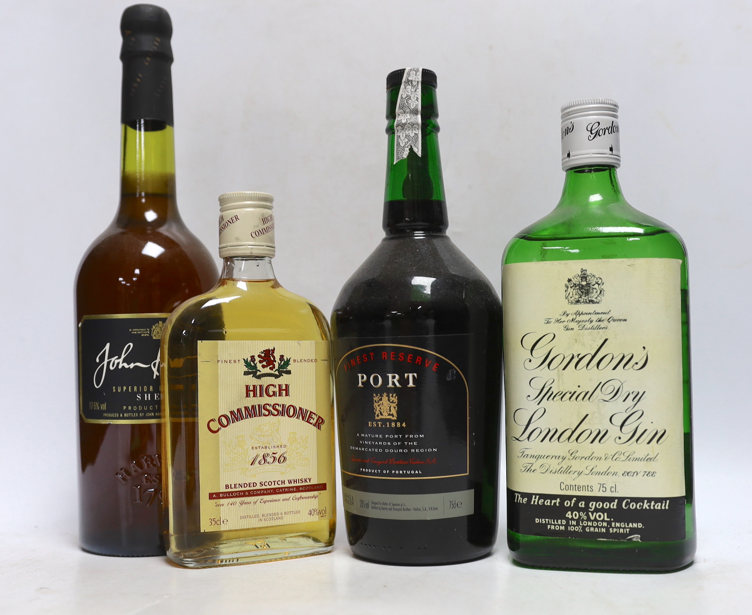 Two 75cl bottles of Gordons gin, two 35cl bottles of whisky, a bottle of sherry and a bottle of port